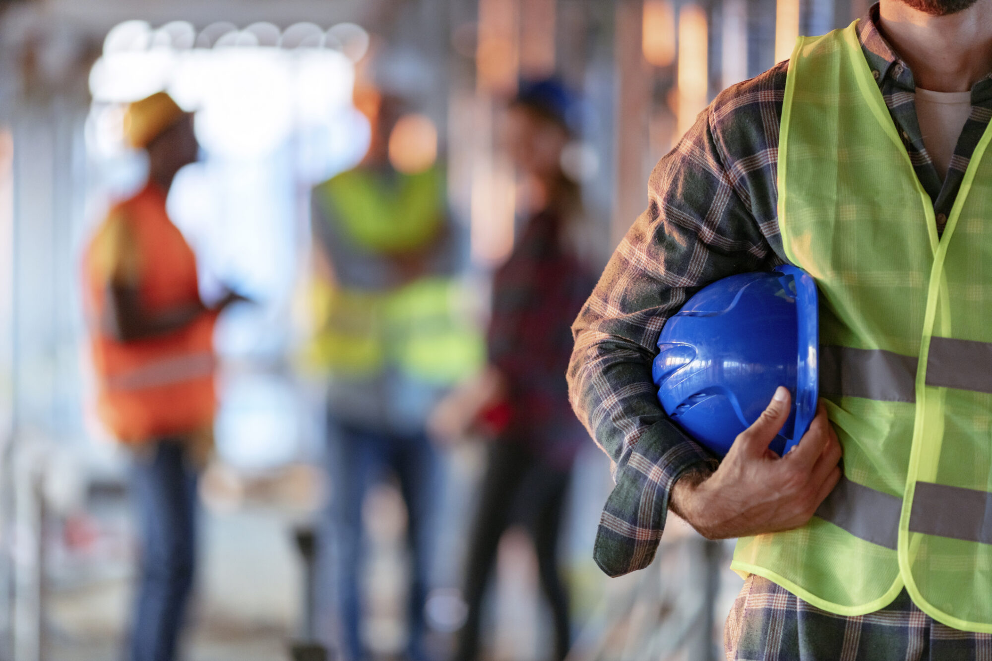 Construction worker with hard helmet and reflective jacket